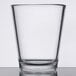A clear Libbey Tritan plastic shot glass on a table.