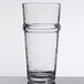 A close-up of a Libbey Tritan plastic beverage glass with a curved rim.
