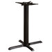 A black Lancaster Table & Seating cast iron table base column on a table.