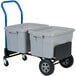 A grey and blue Harper hand truck with a grey plastic container on it.