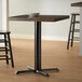 A Lancaster Table & Seating black cast iron counter height column table base.