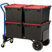 A blue Harper hand truck with black and red containers on it.
