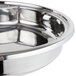 A Vollrath stainless steel food pan in a bowl.