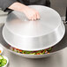 A person using a Town Wok Cover to cover a bowl of food.