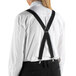 A person wearing Henry Segal black clip-end suspenders over a white shirt.