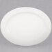 A CAC oval porcelain platter with a white rim on a gray surface.