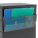A file cabinet with a clear drawer holding a blue and green folder in a Deflecto magnetic file holder.