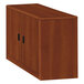 A brown wooden HON 10700 Series storage cabinet with black handles.