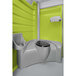 A PolyJohn lime green and grey portable restroom with a toilet and sink.