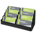 A black plastic Deflecto business card holder with eight pockets holding business cards.