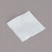 A white square Medi-First alcohol prep pad on a gray surface.