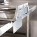 A Vollrath Redco InstaSlice with scalloped blades on a stainless steel tray.