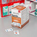 A table with several Medi-First Ibuprofen Tablets boxes.