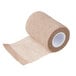 A close-up of a roll of brown Medi-First self-adhesive wrap.