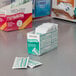 A box of Medi-First Hydrocortisone anti-itch cream packets on a table.