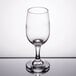 A close-up of a Libbey white wine glass on a reflective surface.