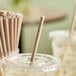 An EcoChoice unwrapped paper straw in a plastic cup.