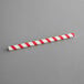 An EcoChoice red and white striped paper straw.