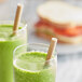 Two glasses of green smoothie with EcoChoice Kraft Giant unwrapped paper straws.