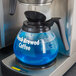 A blue liquid in a glass container with a black lid.