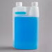 A plastic container of Urnex Rinza Acid Formulation with blue liquid and two white bottles inside.