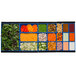 A Tablecraft cobalt blue bowl filled with carrots and peas on a tray of salad bar items.