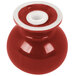 A red and white ceramic salt shaker with a lid on a table.