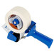 A Shurtape masking tape dispenser with a blue handle.