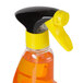 A white spray bottle of orange and yellow Goo Gone Adhesive Remover.
