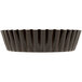 A black non-stick fluted tart pan with a removable bottom.