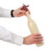 A person holding a Chef Specialties Chateau wine bottle salt mill.