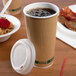 A close-up of an EcoChoice paper hot cup with a lid and a straw.
