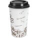 A white paper coffee cup with a brown bean print and a black lid.