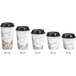 A row of white paper coffee cups with brown bean designs and black lids.
