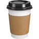 A Choice white paper hot cup with a black lid and sleeve.