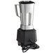 A silver and black Waring Torq 2.0 blender with a cord attached to it.