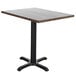 A BFM Seating rectangular table top with a wooden finish on a black table base.