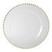 A white plate with gold beaded trim.