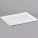 A Winholt white rectangular display tray with a small handle on a gray background.