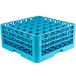 A blue plastic Carlisle glass rack with many compartments and holes.