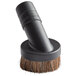 A black brush with a brown handle.