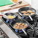Three Choice aluminum non-stick frying pans on a stove.