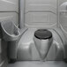 A PolyJohn portable restroom with a seat and a lid.