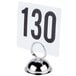 A white table number on a metal stand with black numbers.