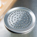 An American Metalcraft 7" Super Perforated Heavy Weight Aluminum Pizza Pan with holes in it.