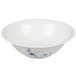 A white bowl with blue and white painted leaves.