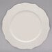 A 10 Strawberry Street white porcelain dinner plate with a decorative design.