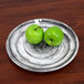 An Elite Global Solutions Van Gogh black melamine plate with a pair of green apples on it.