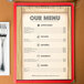 An 8 1/2" x 11" menu with a southwest themed saloon design on the table.