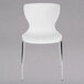 A Flash Furniture white plastic chair with metal legs.